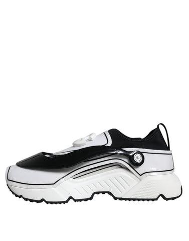 White Dolce & Gabbana Daymaster sneakers with black logo plaque and sleek design, showcasing stylish athletic footwear.
