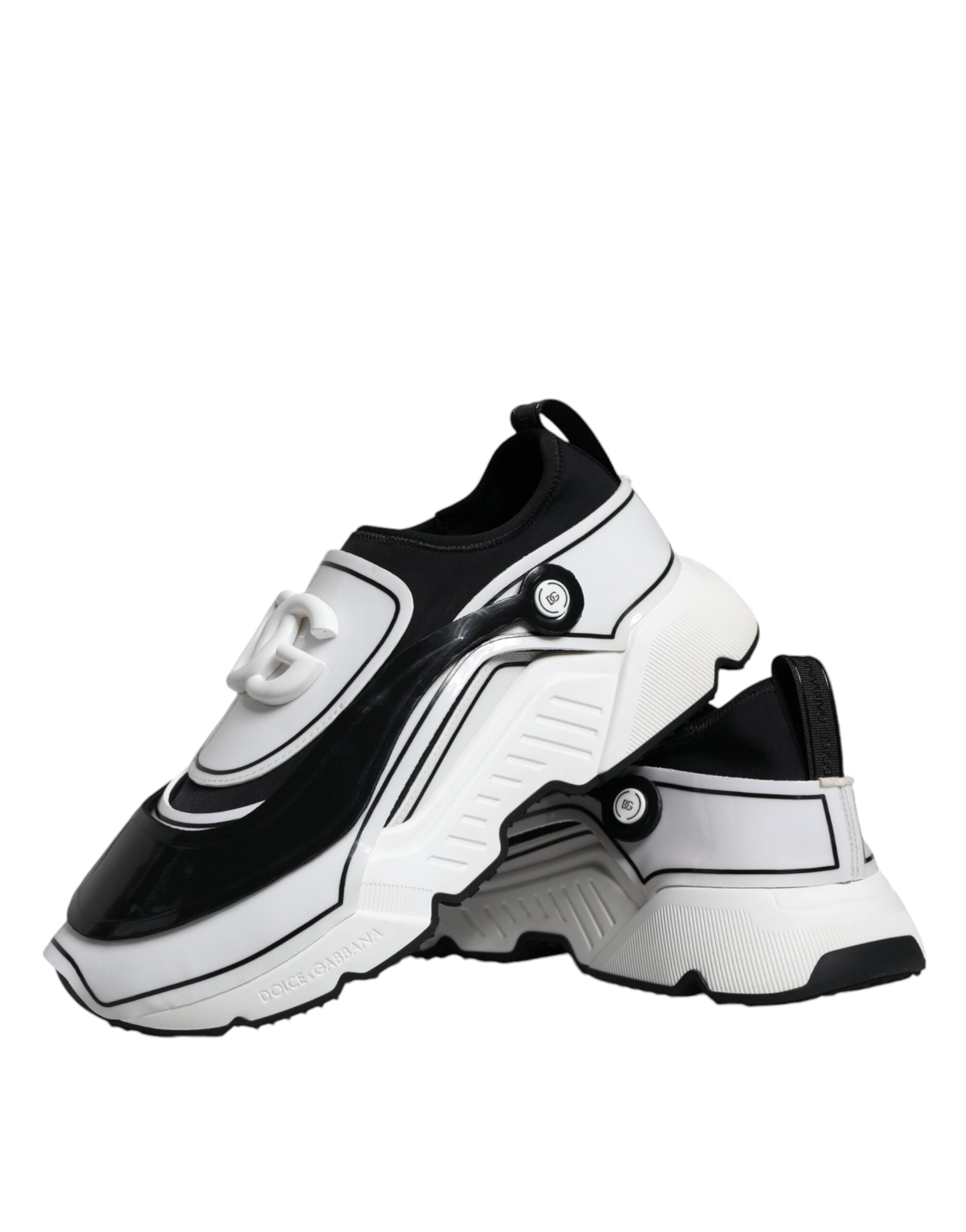 White Dolce & Gabbana Daymaster sneakers with black logo plaque and stylish design, featuring lace-up closure and rubber sole.