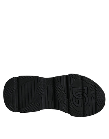 White and black Dolce & Gabbana Daymaster sneakers with logo plaque, showcasing stylish sneaker design and branding details.