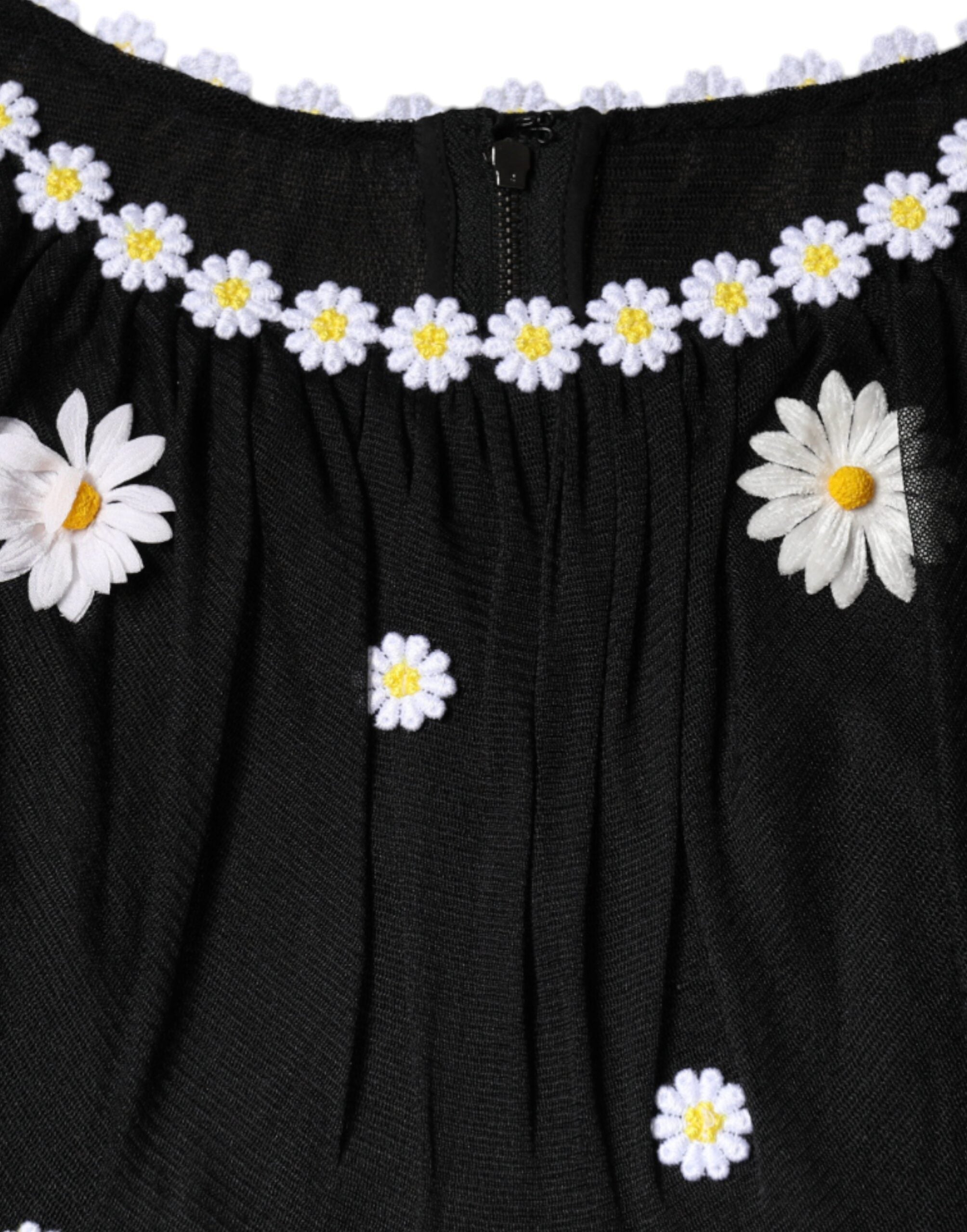 Black silk Daisy A-line long maxi dress by Dolce & Gabbana displayed on a hanger with floral details.