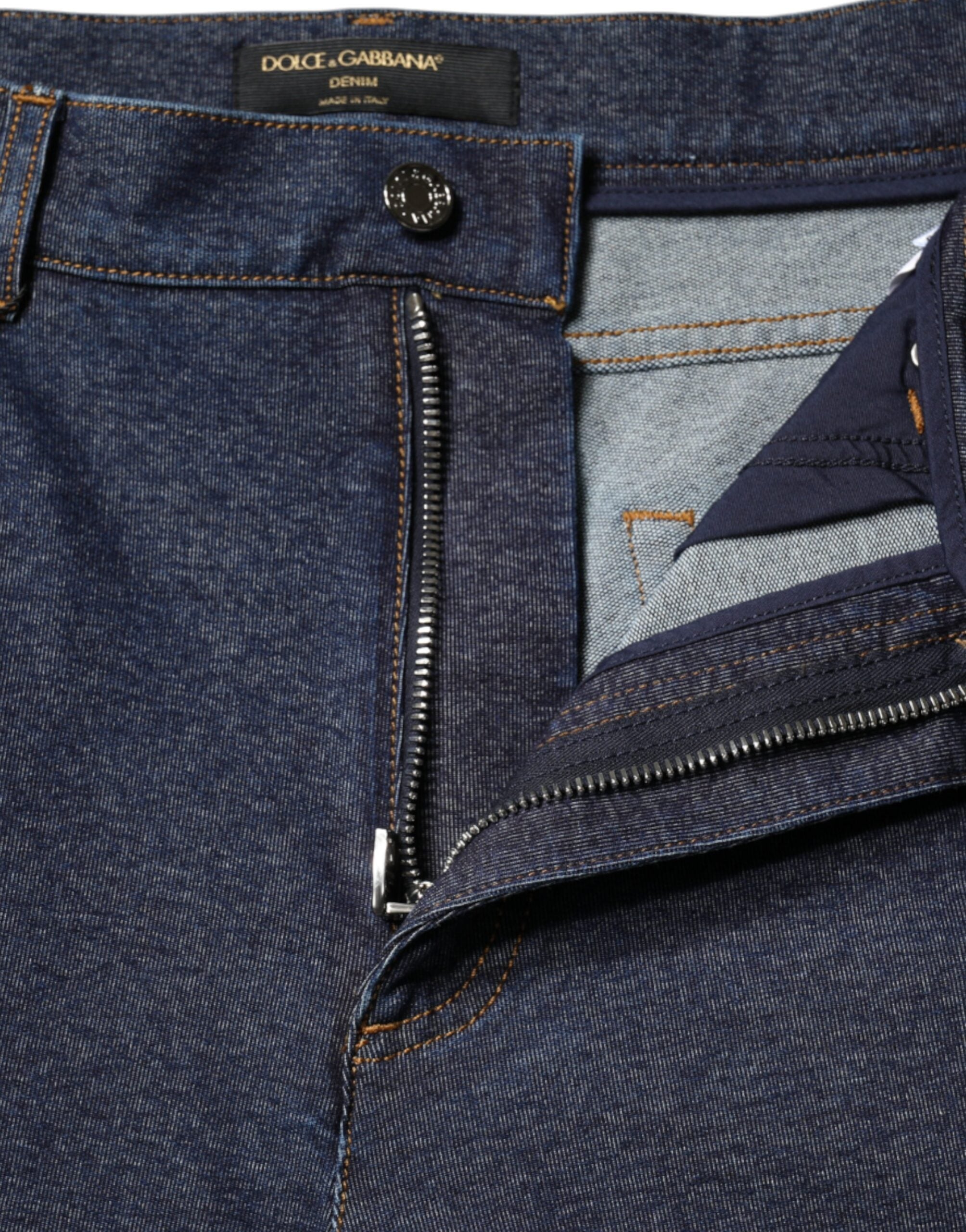 Dark blue cotton stretch straight denim jeans by Dolce & Gabbana, shown hanging with a relaxed fit and classic five-pocket design.