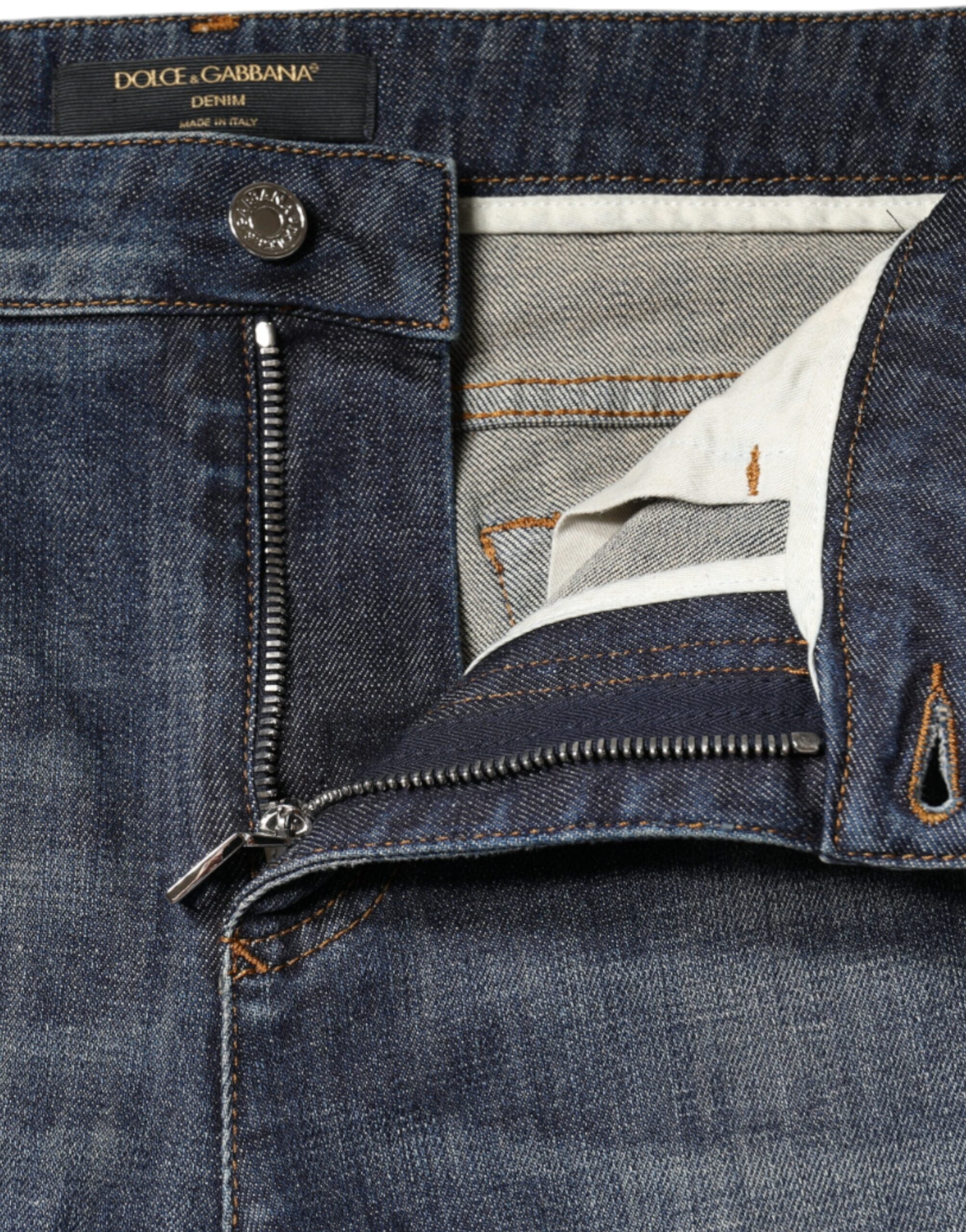Dark blue cotton stretch skinny denim jeans by Dolce & Gabbana, showing close-up of fitted waistband and fabric texture.