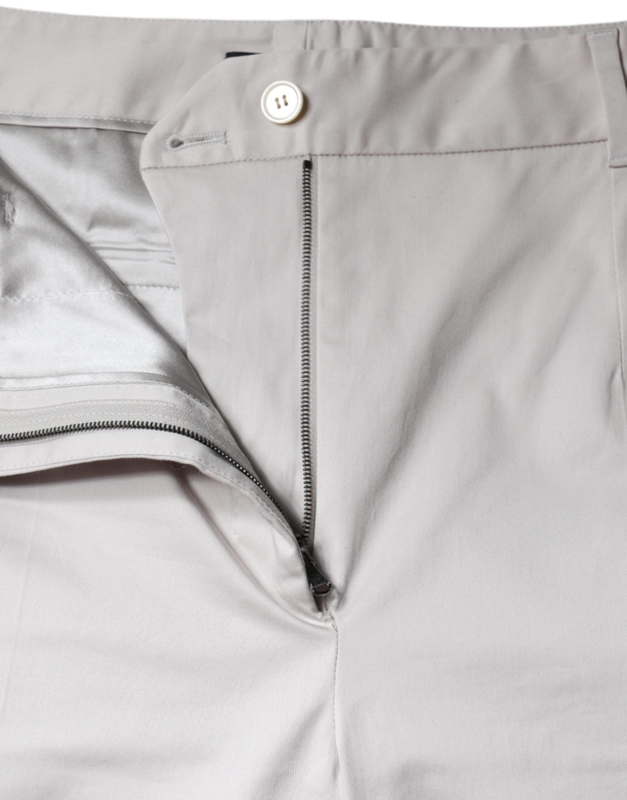 White cotton mid-waist cropped skinny pants by Dolce & Gabbana, showing the fitted design and waistband on a model.