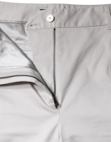 White cotton mid-waist cropped skinny pants by Dolce & Gabbana, showing the fitted design and waistband on a model.