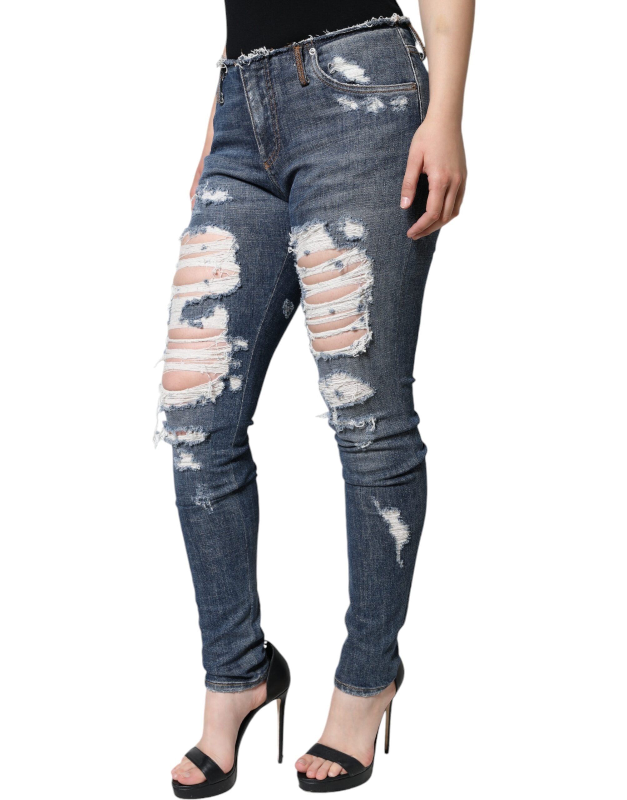 Blue cotton stretch tattered skinny jeans by Dolce & Gabbana, showing distressed details and slim fit design.