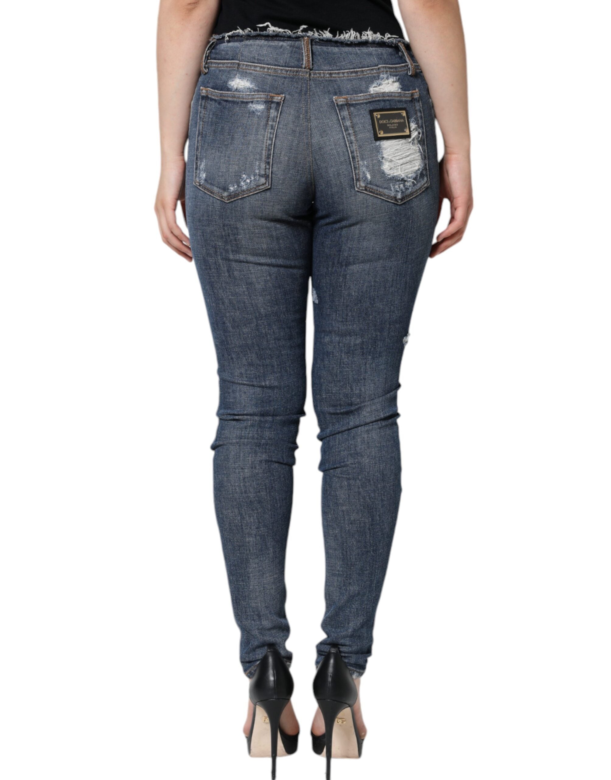 Blue cotton stretch tattered skinny jeans by Dolce & Gabbana, showing distressed details and slim fit style.