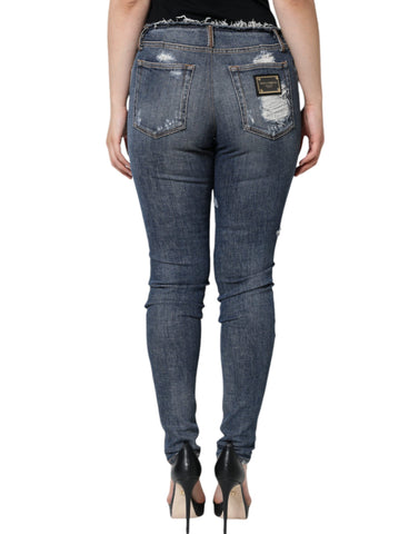 Blue cotton stretch tattered skinny jeans by Dolce & Gabbana, showing distressed details and slim fit style.
