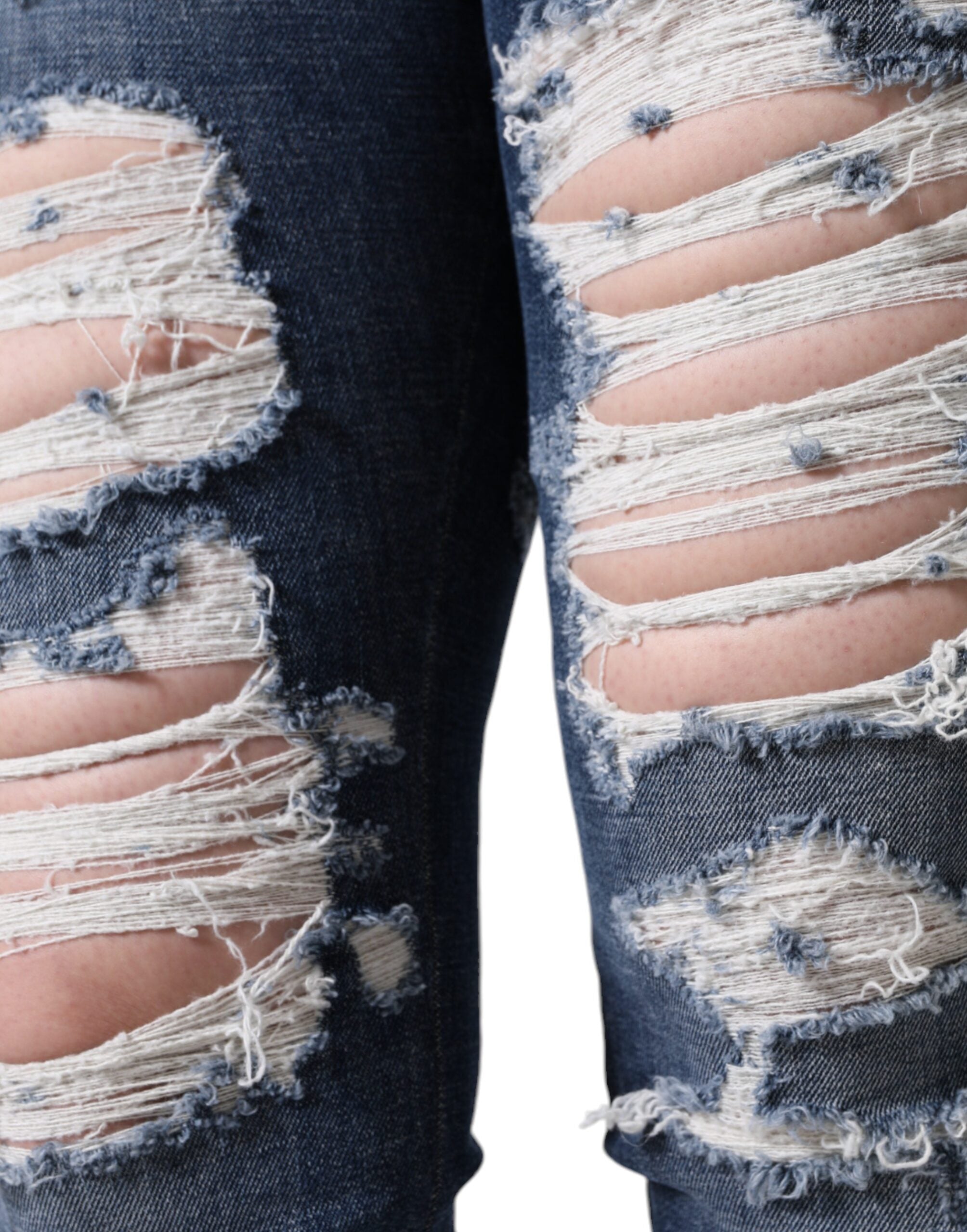 Blue cotton stretch tattered skinny jeans by Dolce & Gabbana displayed on a hanger.