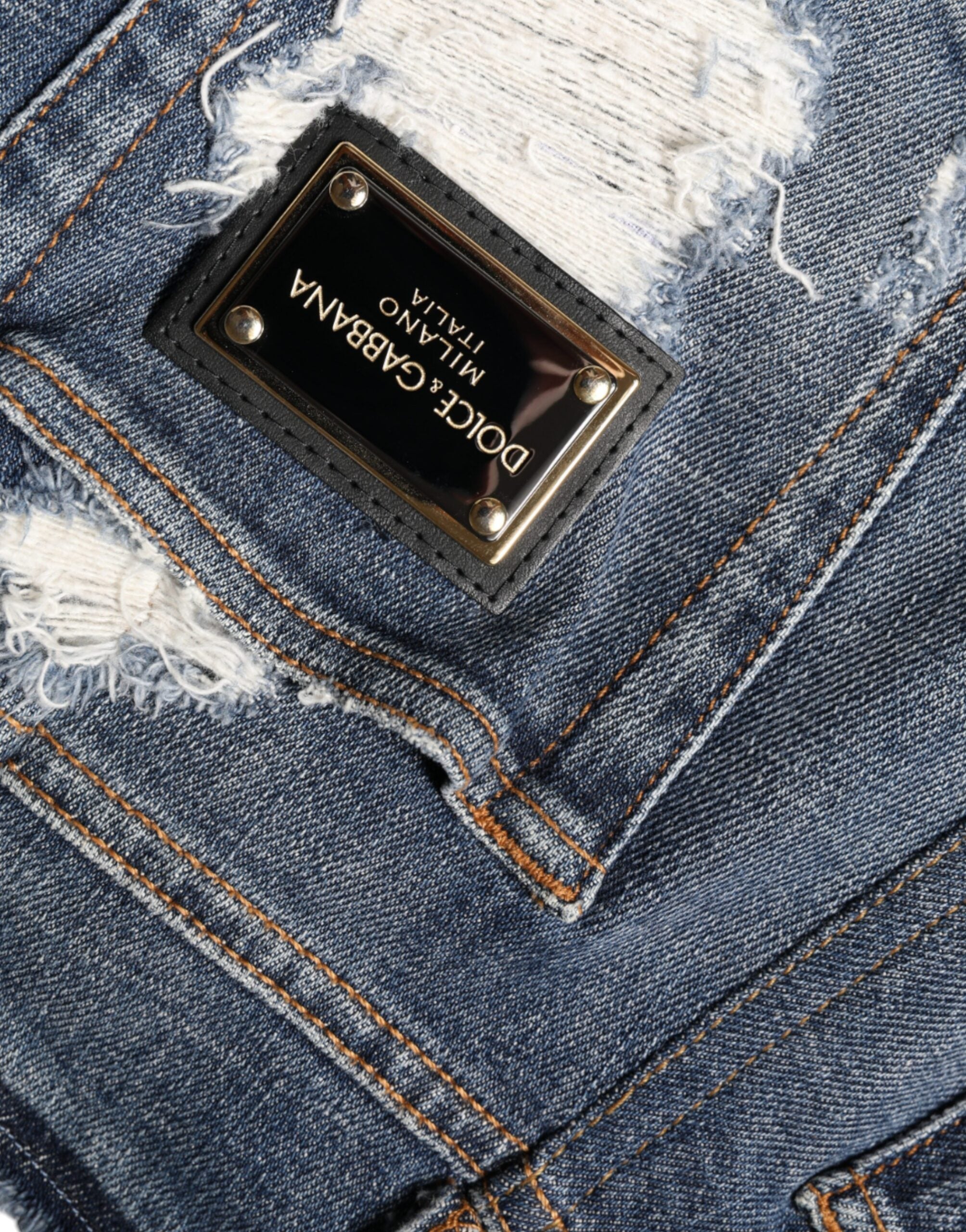 Blue cotton stretch tattered skinny jeans by Dolce & Gabbana, showing distressed details and slim fit cut.