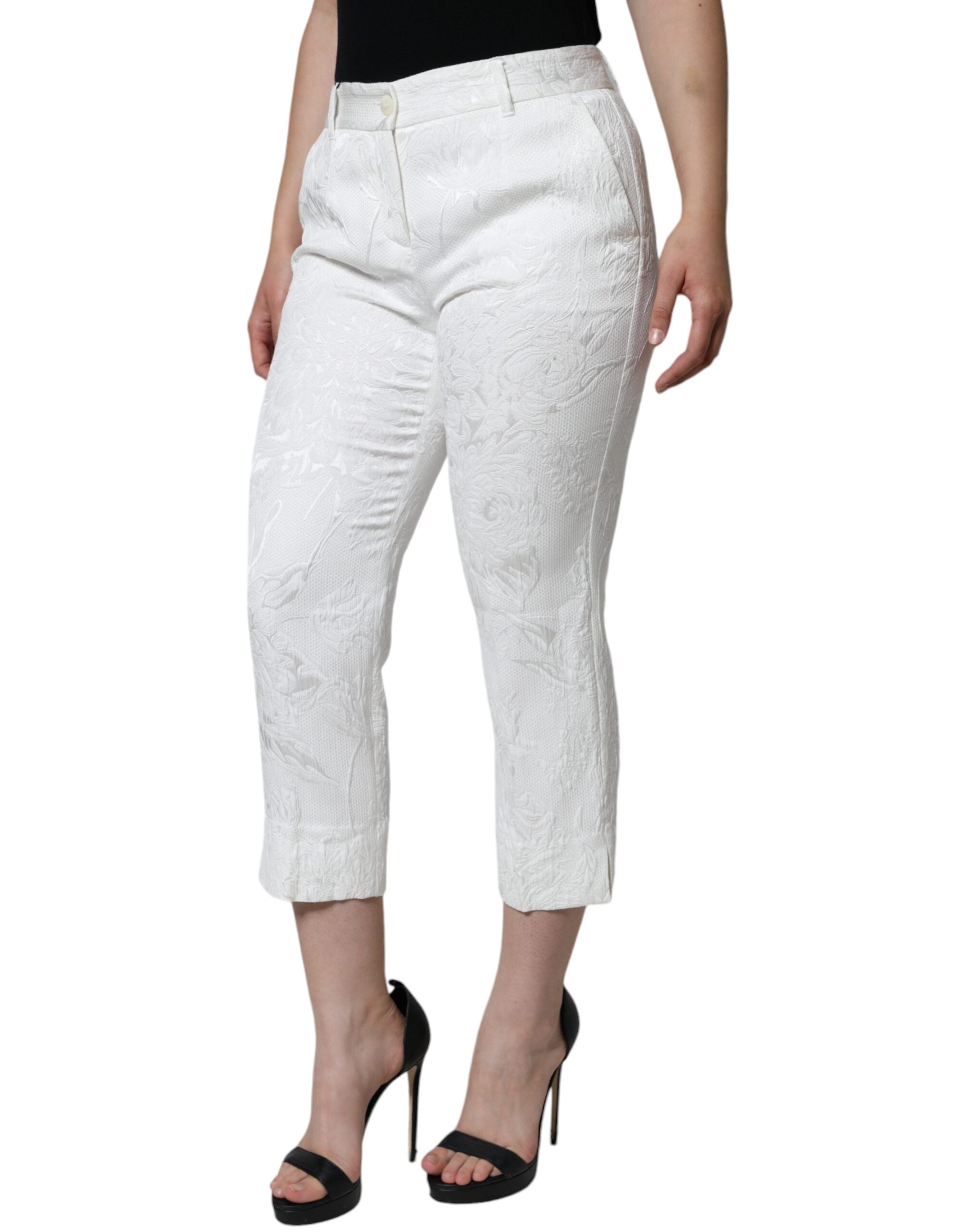 White floral brocade cotton cropped pants by Dolce & Gabbana with a tailored fit and intricate floral pattern.