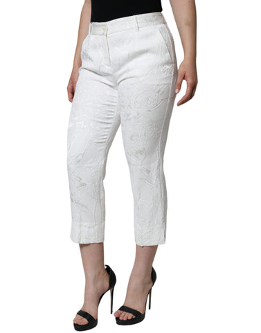 White floral brocade cotton cropped pants by Dolce & Gabbana with a tailored fit and intricate floral pattern.