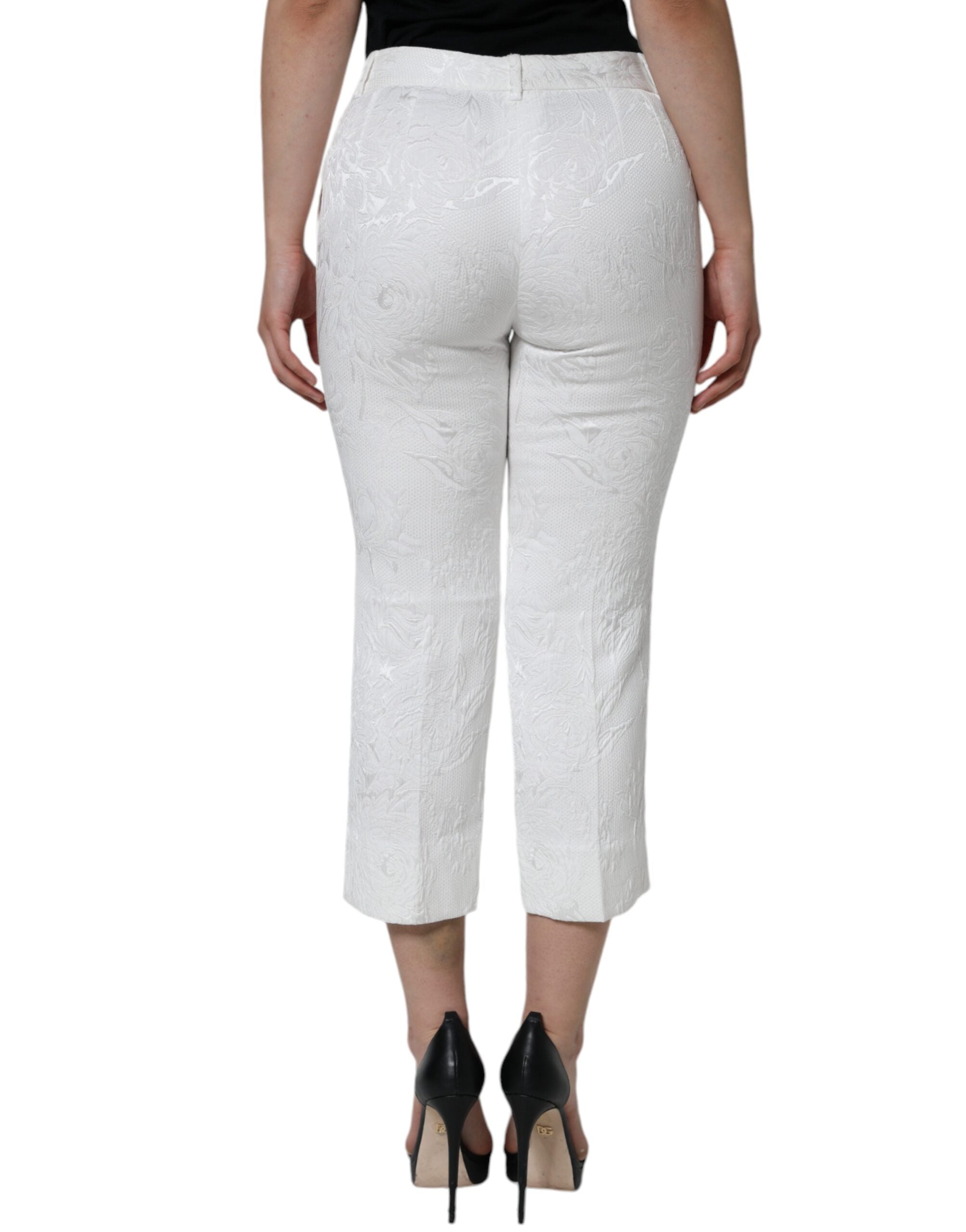White floral brocade cotton cropped pants by Dolce & Gabbana, featuring intricate floral patterns and a stylish tailored fit.