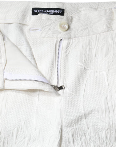 White floral brocade cotton cropped pants by Dolce & Gabbana, featuring intricate floral pattern and tailored fit.