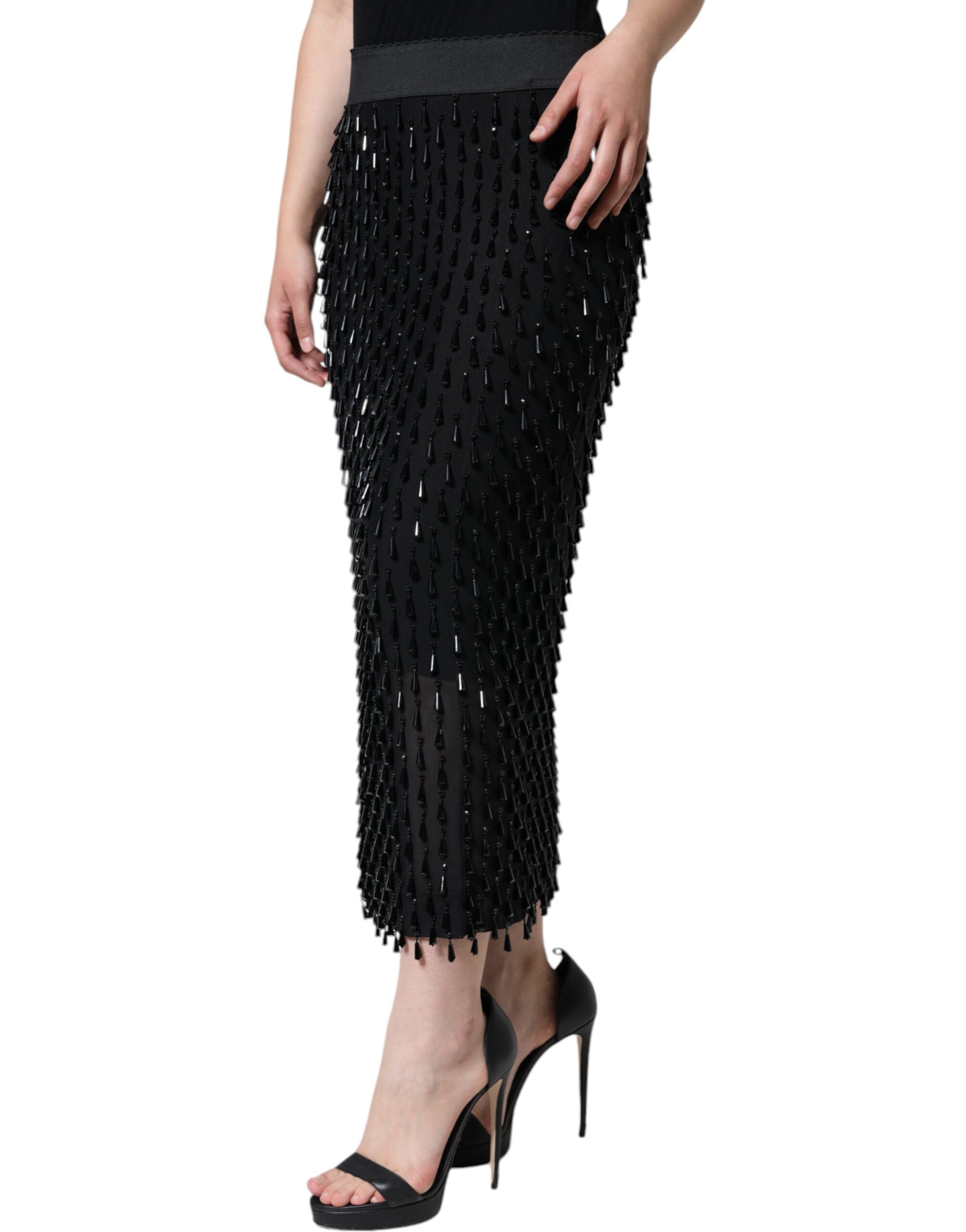 Black embellished pencil cut midi skirt by Dolce & Gabbana with intricate beadwork and a fitted silhouette.