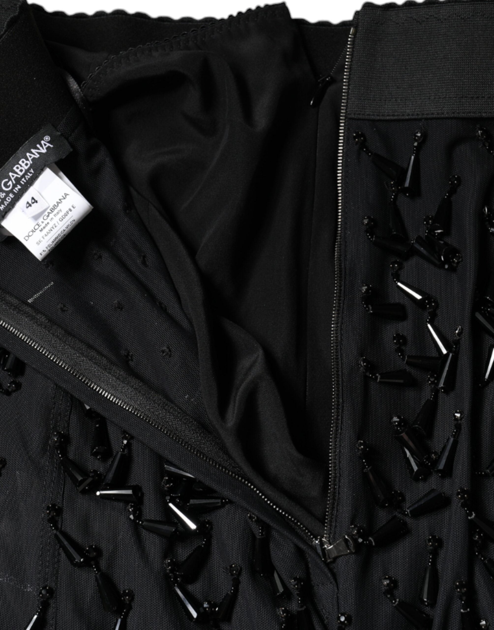 Black embellished pencil cut midi skirt by Dolce & Gabbana with intricate detailing and a sleek, fitted silhouette.
