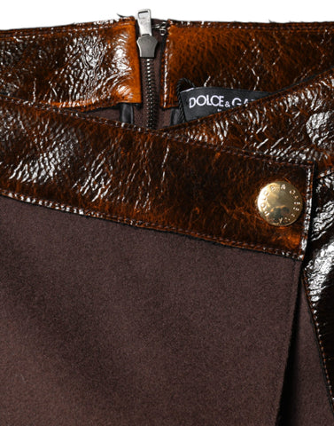 Brown virgin wool A-line mini skirt by Dolce & Gabbana, mid waist fit, showcased on a hanger with a textured fabric background.
