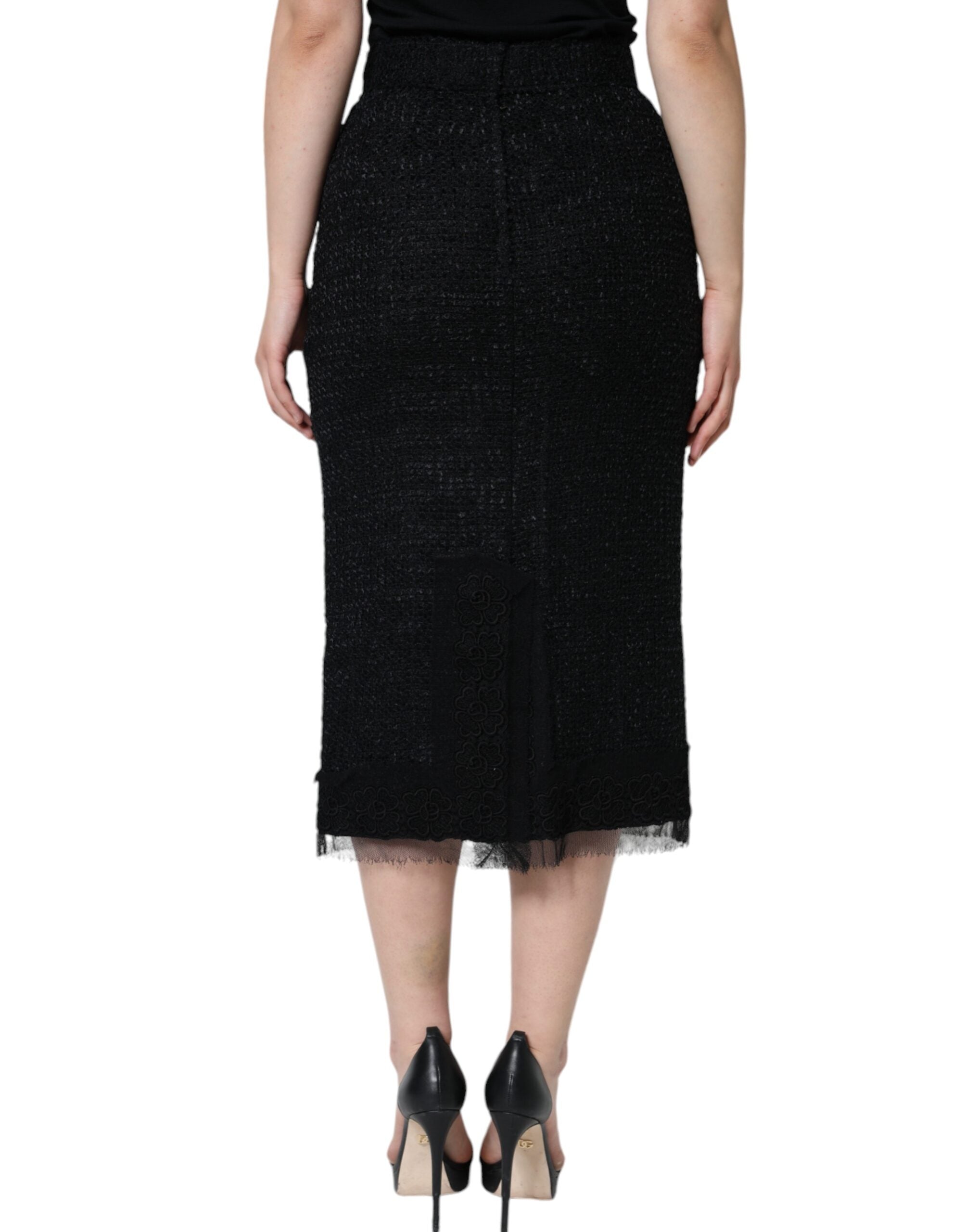 Black virgin wool pencil cut midi skirt by Dolce & Gabbana, shown on a model with a fitted waist and sleek silhouette.
