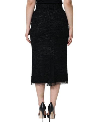 Black virgin wool pencil cut midi skirt by Dolce & Gabbana, shown on a model with a fitted waist and sleek silhouette.