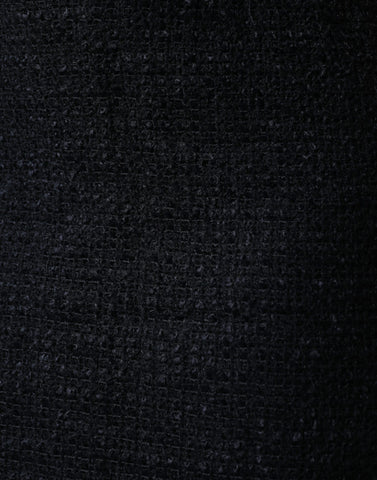 Black virgin wool pencil cut midi skirt by Dolce & Gabbana, shown on a model with a sleek, fitted silhouette.