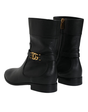 Black leather mid-calf boots with Dolce & Gabbana logo, stylish footwear featuring sleek design and sturdy heel.