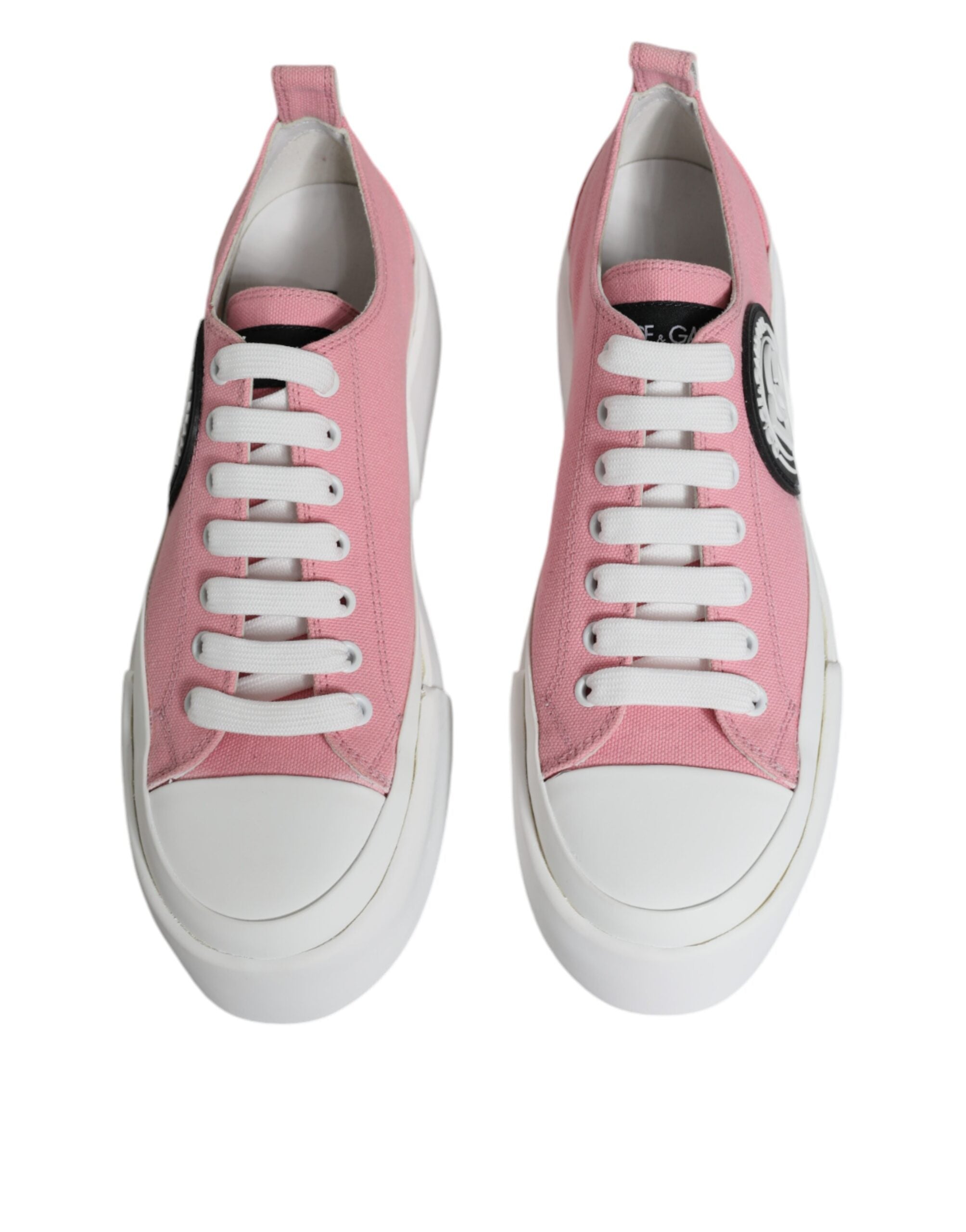 Pink and white canvas low top sneakers with Dolce & Gabbana logo, featuring casual style and comfortable fit.