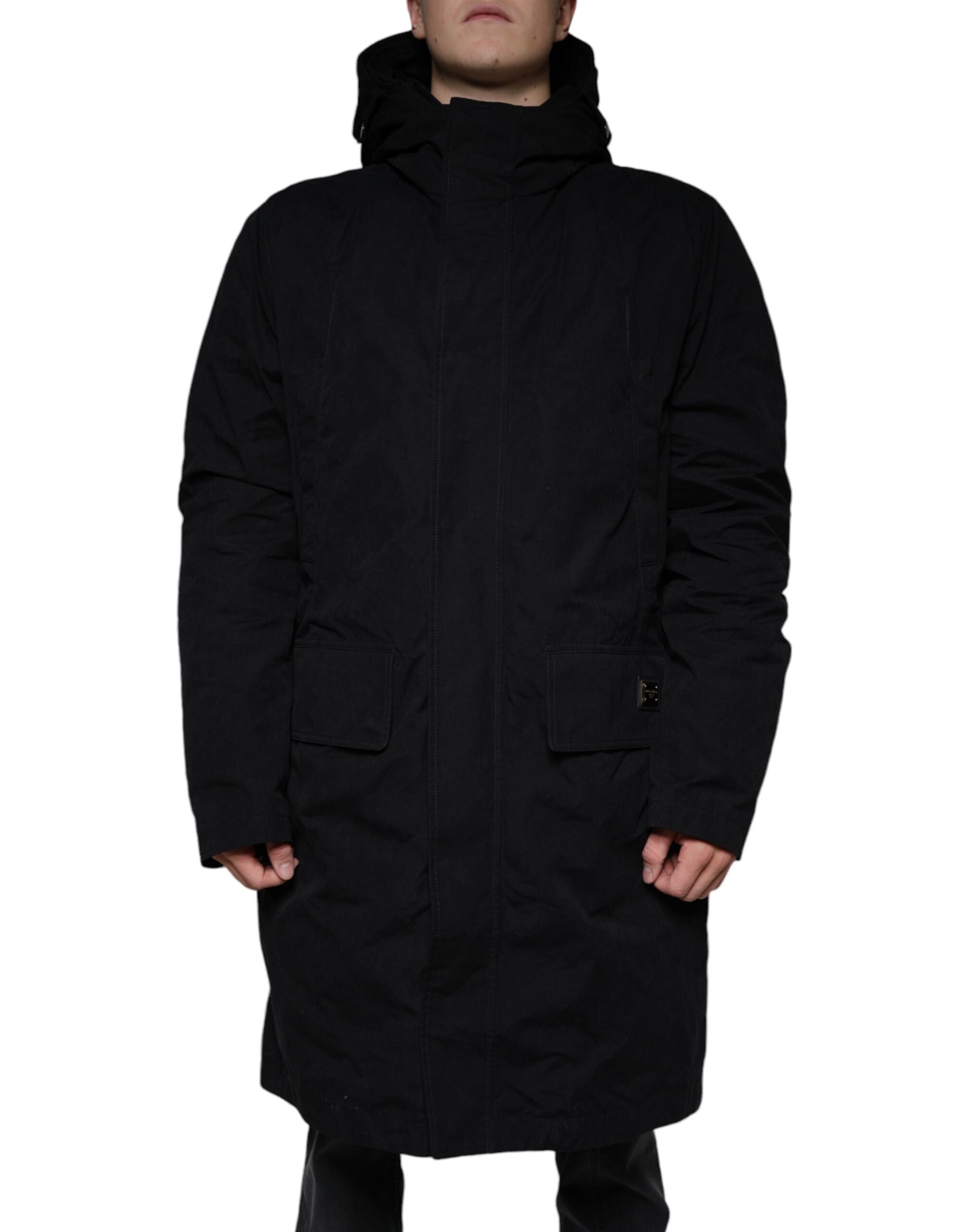 Black hooded cotton parka trench coat by Dolce & Gabbana with a front zipper and hood, displayed on a hanger.