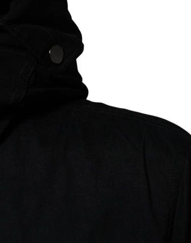 Black hooded parka cotton trench coat jacket by Dolce & Gabbana, featuring a sleek design with a hood and button closure.