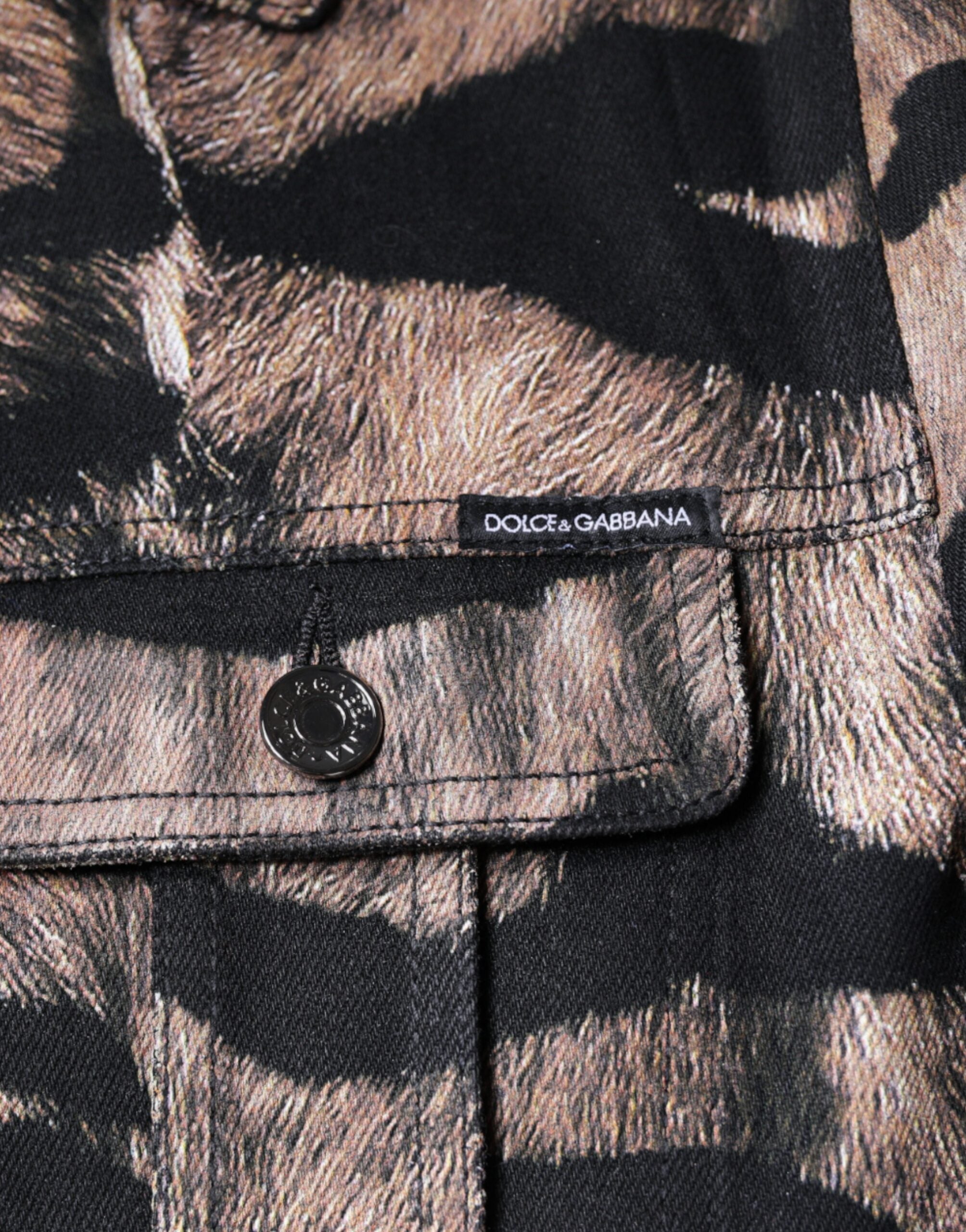 Brown tiger print button-down collared jacket by Dolce & Gabbana displayed on a hanger.