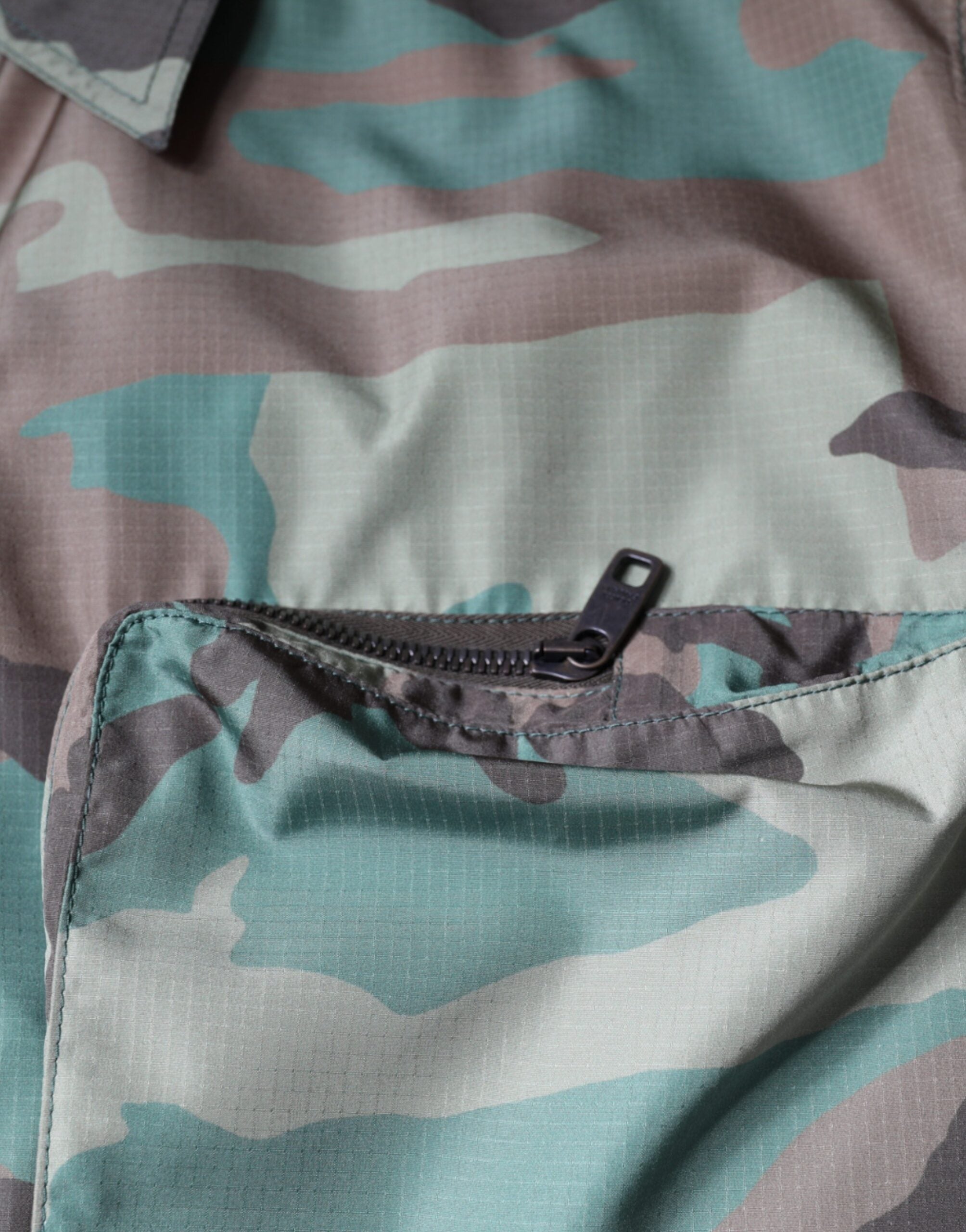 Multicolor camouflage button-down shirt by Dolce & Gabbana featuring a stylish camo pattern and classic collar.