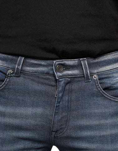 Dark blue washed cotton skinny denim jeans by Dolce & Gabbana, showing fitted style, front pockets, and classic stitching.