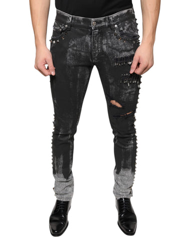 Black embellished cotton skinny denim jeans by Dolce & Gabbana, featuring detailed embellishments and a fitted style.