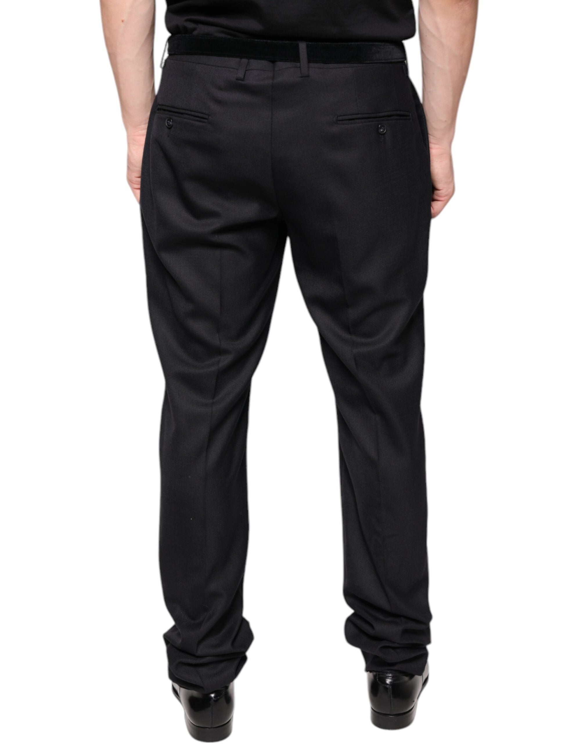 Black wool skinny dress pants by Dolce & Gabbana, tailored formal pants with a sleek fit, shown on a model.