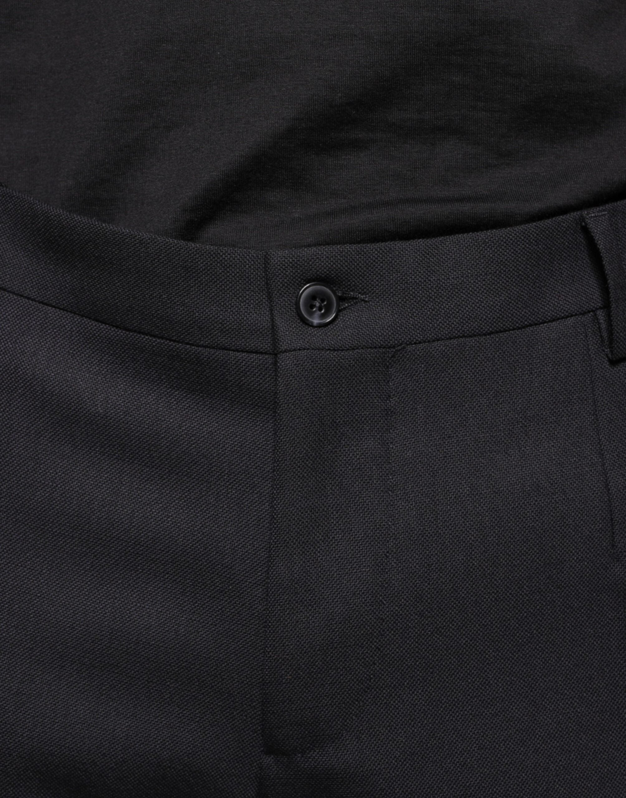 Black wool skinny formal pants by Dolce & Gabbana, showing a close-up of the tailored fit and fabric texture.