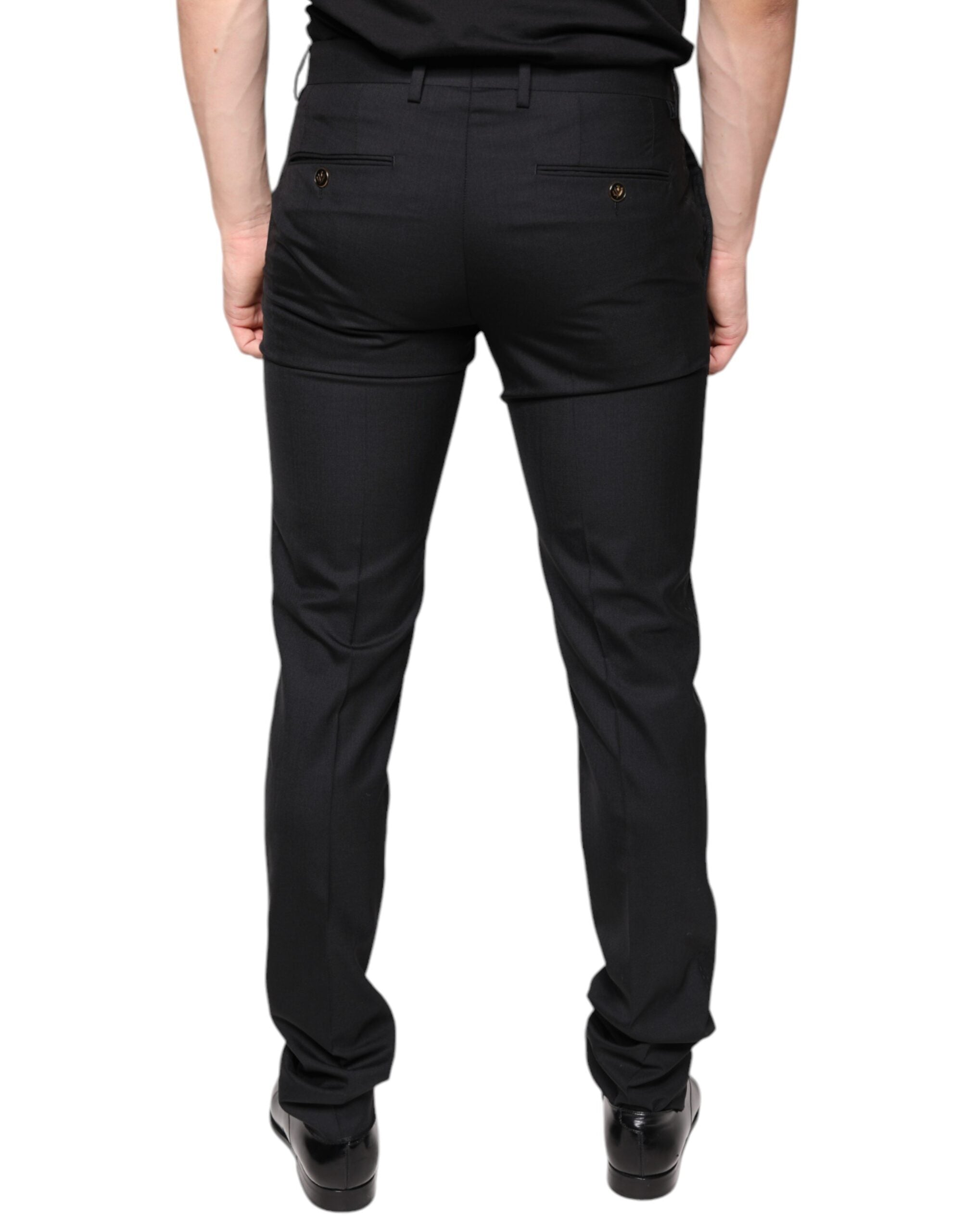 Black wool skinny men's dress pants by Dolce & Gabbana, tailored fit with sleek design, shown on a hanger.