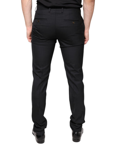 Black wool skinny men's dress pants by Dolce & Gabbana, tailored fit with sleek design, shown on a hanger.