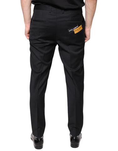 Black wool skinny men's dress pants by Dolce & Gabbana shown on a model, featuring a tailored fit and classic design.