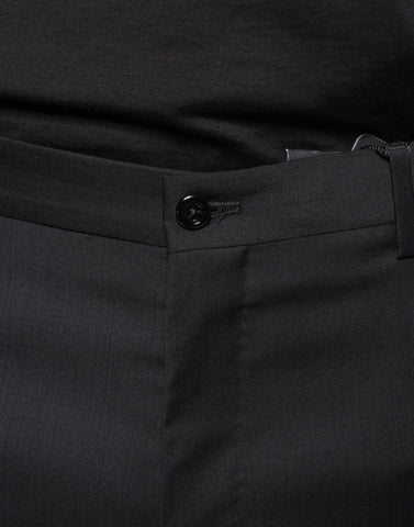 Black wool skinny men's dress pants by Dolce & Gabbana, tailored fit with smooth fabric and classic style.