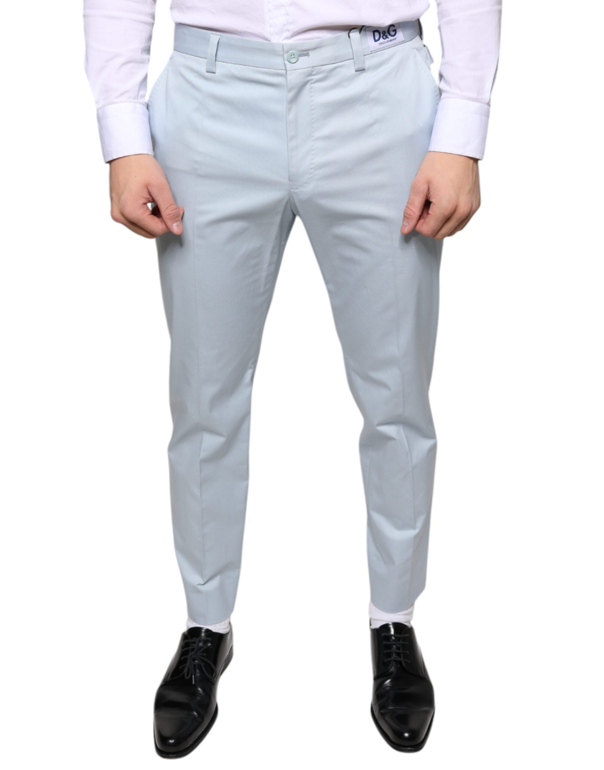 Light blue cotton dress pants by Dolce & Gabbana with a tailored fit and classic design, shown on a model.