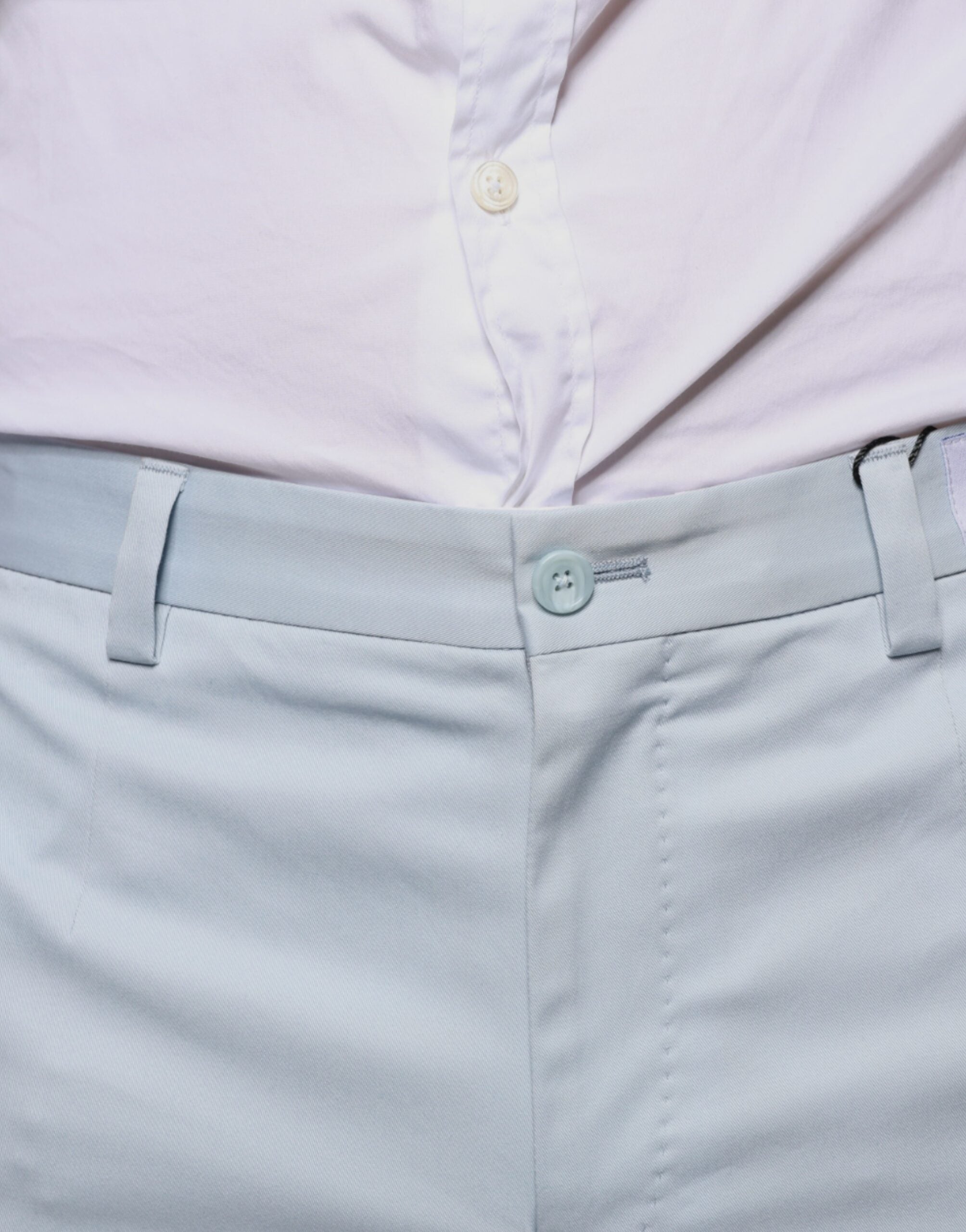 Light blue cotton dress pants by Dolce & Gabbana, tailored fit with classic waistband and crease front, suitable for formal wear.