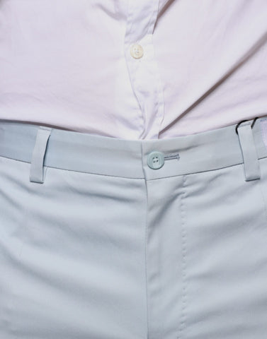 Light blue cotton dress pants by Dolce & Gabbana, tailored fit with classic waistband and crease front, suitable for formal wear.