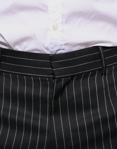 Black striped skinny men's dress pants by Dolce & Gabbana, tailored fit with sleek design and subtle stripe pattern.