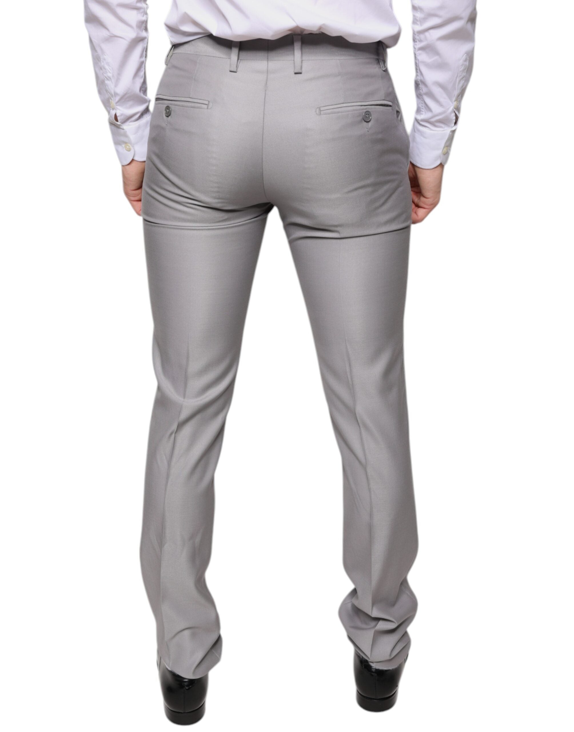 Light gray wool dress pants by Dolce & Gabbana, tailored fit with classic waistband and crease detail, suitable for formal wear.