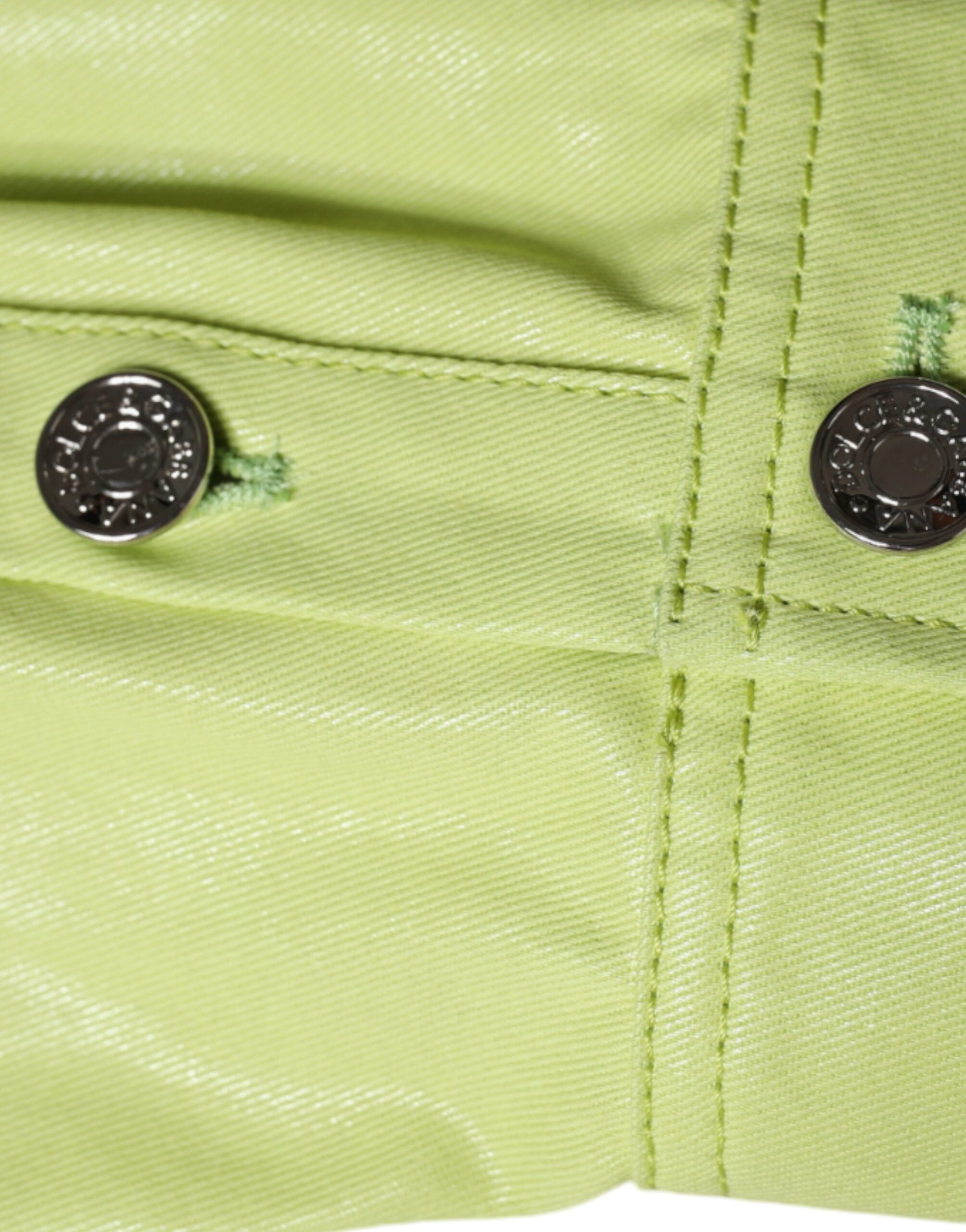 Green cotton collared men's button-down shirt by Dolce & Gabbana, shown on a hanger with visible collar and button details.