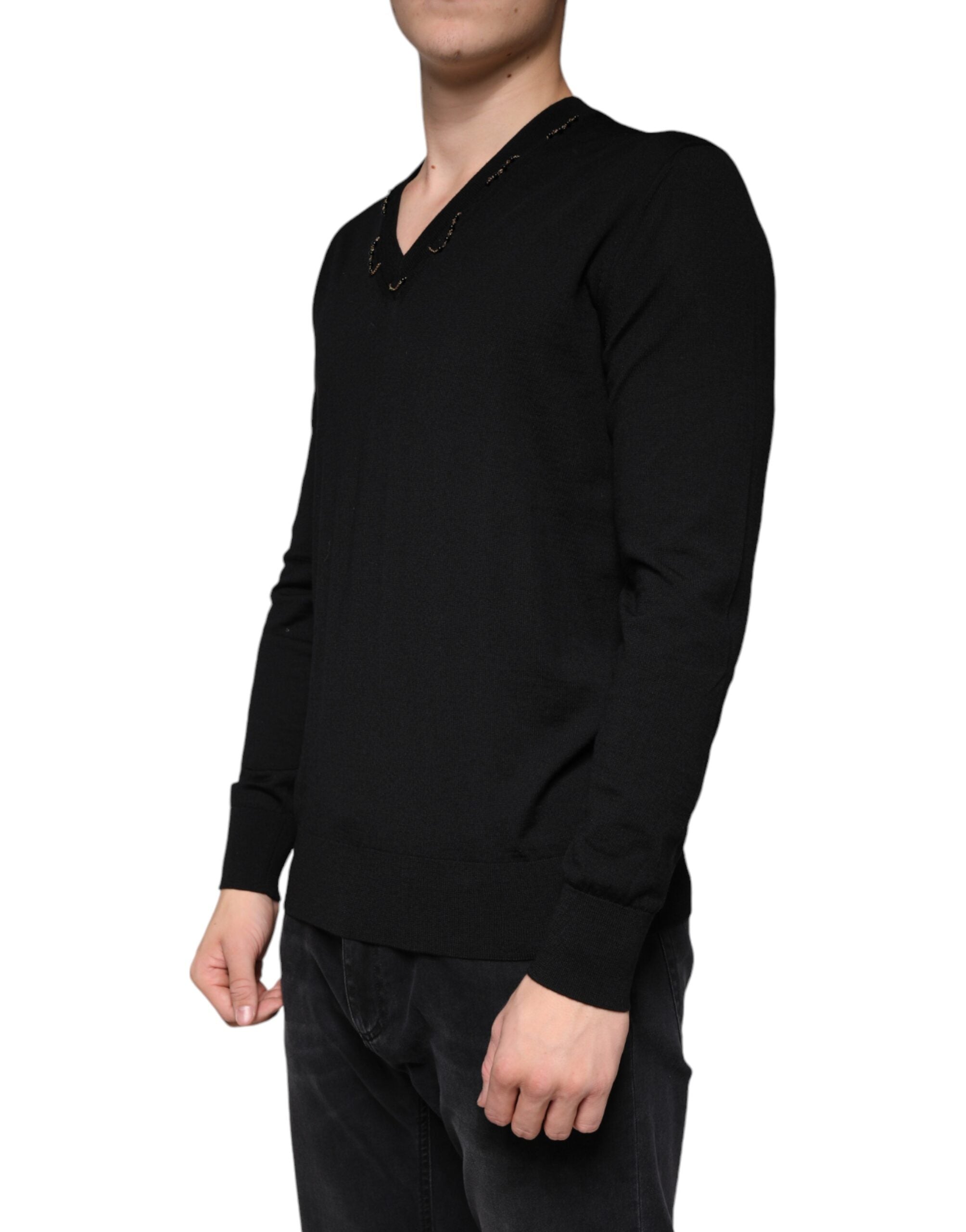 Black embellished V-neck pullover sweater by Dolce & Gabbana featuring intricate embellishments and a classic V-neck design.