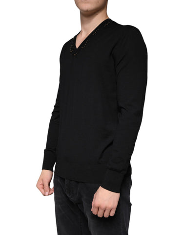 Black embellished V-neck pullover sweater by Dolce & Gabbana featuring intricate embellishments and a classic V-neck design.