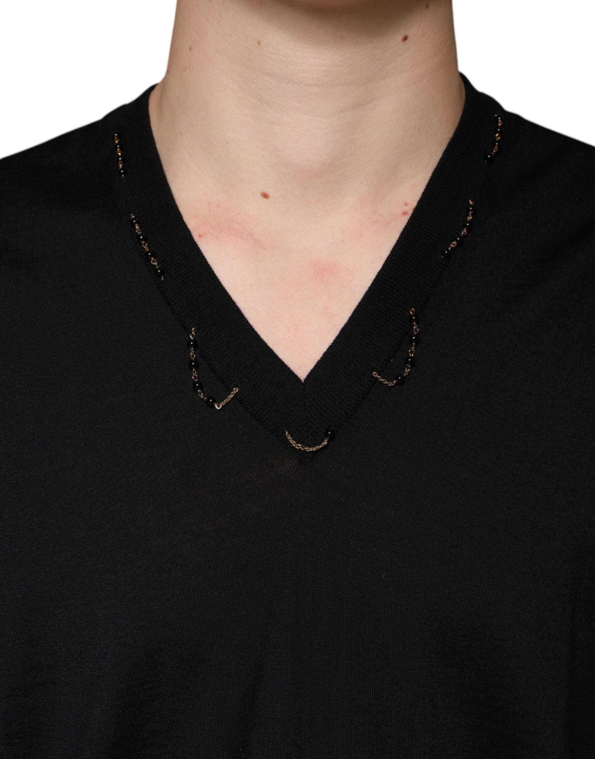 Black embellished V-neck pullover sweater by Dolce & Gabbana with intricate beadwork and a relaxed fit.
