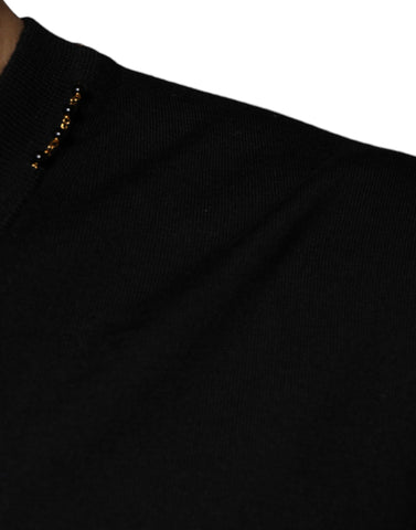 Black embellished V-neck pullover sweater by Dolce & Gabbana, featuring intricate embellishments and a classic V-neck design.