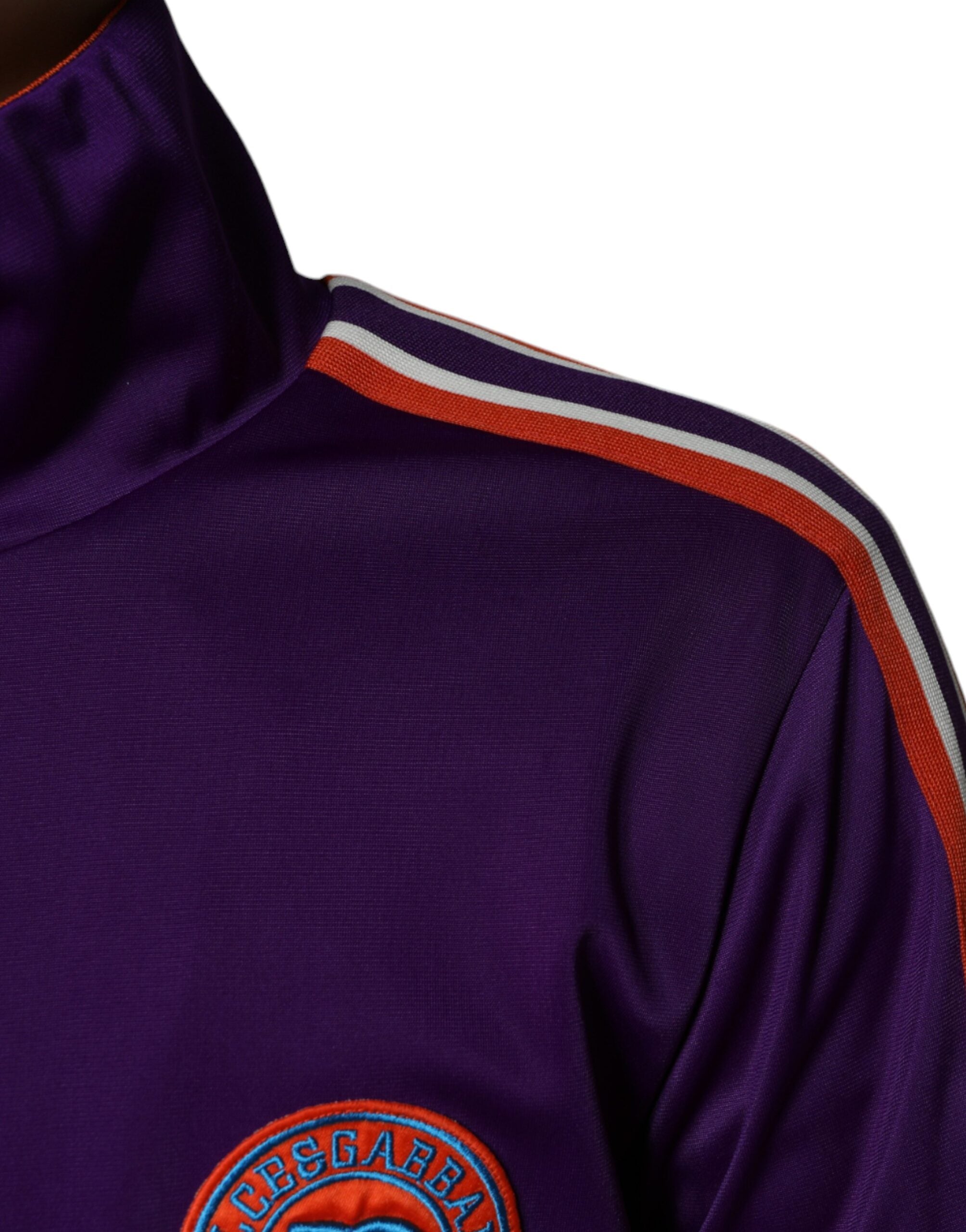 Purple polyester full-zip long sleeve sweater by Dolce & Gabbana, shown on a hanger with visible zipper and ribbed cuffs.