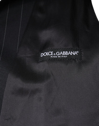 Black leather waistcoat dress with formal vest style by Dolce & Gabbana, shown on a mannequin.