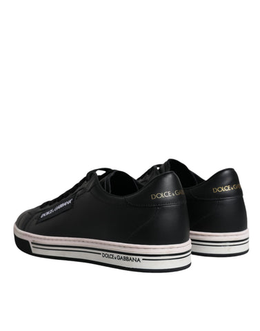 Black leather low top men's sneakers by Dolce & Gabbana, featuring sleek design and classic lace-up style.